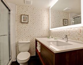 Guest bathroom with shower and free toiletries at Holiday Inn Ottawa Downtown Parliament Hill.