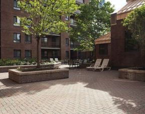 Outdoor patio with lounge seating at Les Suites Hotel Ottawa.