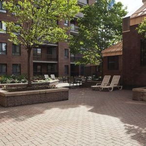 Outdoor patio with lounge seating at Les Suites Hotel Ottawa.