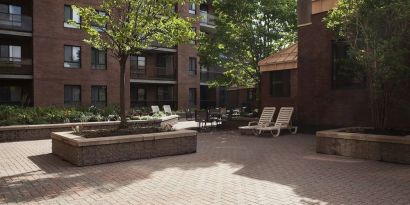 Outdoor patio with lounge seating at Les Suites Hotel Ottawa.