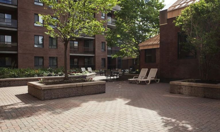 Outdoor patio with lounge seating at Les Suites Hotel Ottawa.