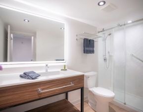 Guest bathroom with shower and free toiletries at Les Suites Hotel Ottawa.