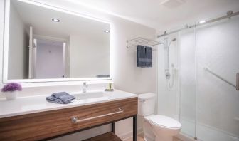 Guest bathroom with shower and free toiletries at Les Suites Hotel Ottawa.