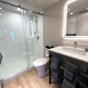 Guest bathroom with shower at Les Suites Hotel Ottawa.