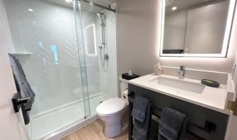 Guest bathroom with shower at Les Suites Hotel Ottawa.