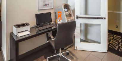 Business center with computer, printer, ergonomic chair and ATM at Comfort Inn Edmonton West.