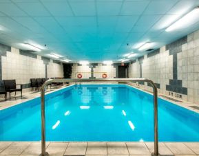 Indoor heated pool with lounge chairs at Halifax Airport Hotel.