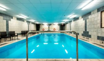 Indoor heated pool with lounge chairs at Halifax Airport Hotel.