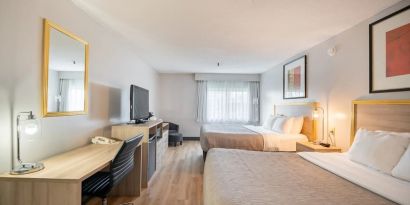 Bright and spacious day use twin room with work desk at Halifax Airport Hotel.