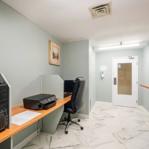 Business center with computers, printer and ergonomic chairs at Halifax Airport Hotel.