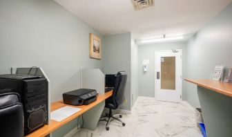 Business center with computers, printer and ergonomic chairs at Halifax Airport Hotel.