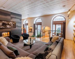 Lobby lounge with fireplace and workspace at Hotel Gault.