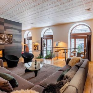 Lobby lounge with fireplace and workspace at Hotel Gault.