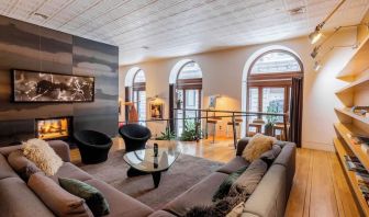 Lobby lounge with fireplace and workspace at Hotel Gault.