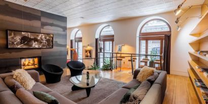 Lobby lounge with fireplace and workspace at Hotel Gault.