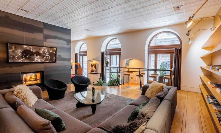 Lobby lounge with fireplace and workspace at Hotel Gault.