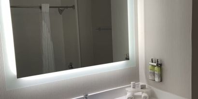 Guest bathroom with shower at Holiday Inn Express & Suites Hermosa Beach.