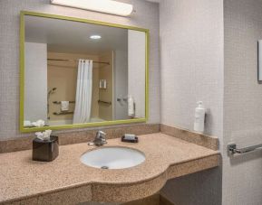 Guest bathroom with shower and tub at Hampton Inn & Suites Dallas/Allen.