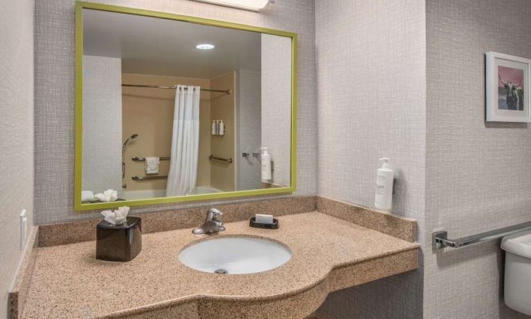 Guest bathroom with shower and tub at Hampton Inn & Suites Dallas/Allen.