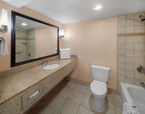 Guest bathroom with shower and tub at La Quinta Inn & Suites San Antonio Medical Center NW.