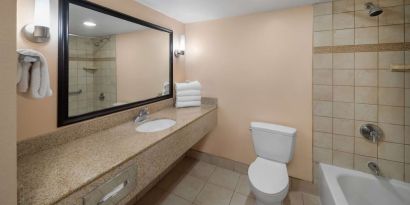 Guest bathroom with shower and tub at La Quinta Inn & Suites San Antonio Medical Center NW.