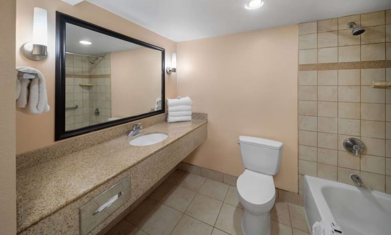 Guest bathroom with shower and tub at La Quinta Inn & Suites San Antonio Medical Center NW.