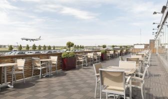 Hotel terrace with comfortable seating and airport view at Thistle London Heathrow Terminal 5.