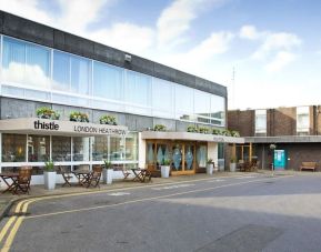 Hotel entrance with outdoor sitting area at Thistle London Heathrow Terminal 5.