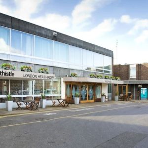 Hotel entrance with outdoor sitting area at Thistle London Heathrow Terminal 5.