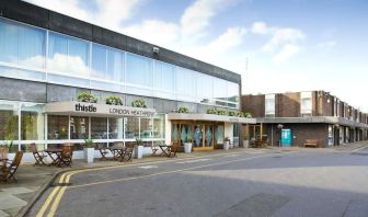 Hotel entrance with outdoor sitting area at Thistle London Heathrow Terminal 5.