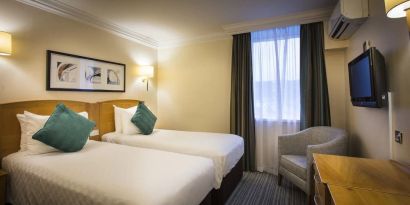 Day use twin room with work desk and sofa at Thistle London Heathrow Terminal 5.