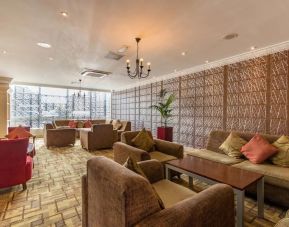 Bright and spacious lobby lounge with comfortable seating perfect for co-working at Thistle London Heathrow Terminal 5.