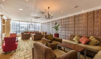 Bright and spacious lobby lounge with comfortable seating perfect for co-working at Thistle London Heathrow Terminal 5.