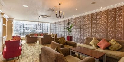 Bright and spacious lobby lounge with comfortable seating perfect for co-working at Thistle London Heathrow Terminal 5.