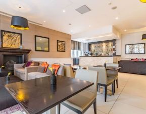 Hotel bar with comfortable seating and fireplace at Thistle Holborn, The Kingsley Hotel.