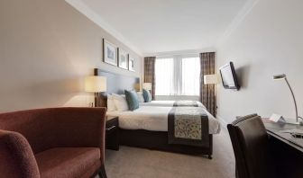 Day use twin room with work desk and sofa at Thistle Royal Trafalgar Square.