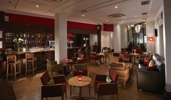 Hotel bar with lounge seating at Thistle Royal Trafalgar Square.