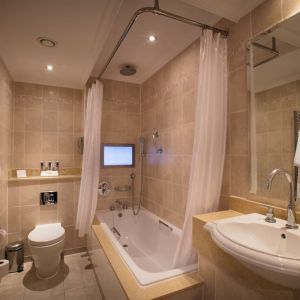 Guest bathroom with tub at The Royal Horseguards Hotel.