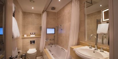 Guest bathroom with tub at The Royal Horseguards Hotel.