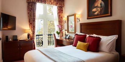 Day room with work desk and TV at The Royal Horseguards Hotel.