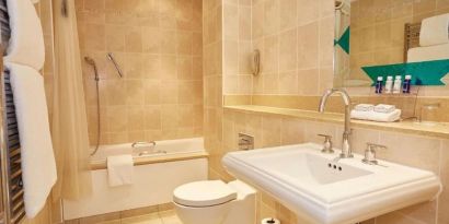 Guest bathroom with tub and free toiletries at The Royal Horseguards Hotel.