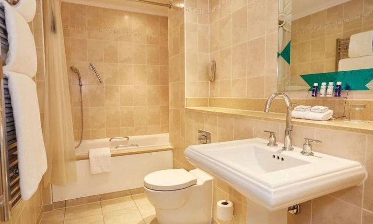 Guest bathroom with tub and free toiletries at The Royal Horseguards Hotel.