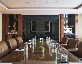 Professional meeting room with comfortable seating and TV screen at The Royal Horseguards Hotel.