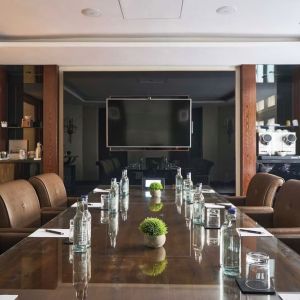 Professional meeting room with comfortable seating and TV screen at The Royal Horseguards Hotel.