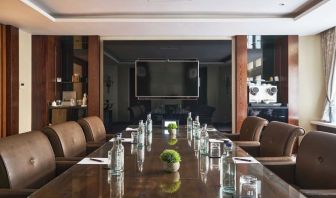 Professional meeting room with comfortable seating and TV screen at The Royal Horseguards Hotel.