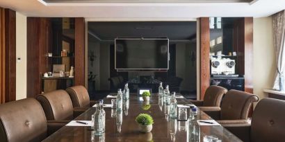 Professional meeting room with comfortable seating and TV screen at The Royal Horseguards Hotel.