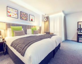 Bright and spacious day use twin room with work desk, sofa, mini bar and coffee maker at Mercure Hotel London Paddington.