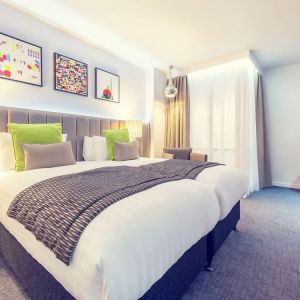 Bright and spacious day use twin room with work desk, sofa, mini bar and coffee maker at Mercure Hotel London Paddington.