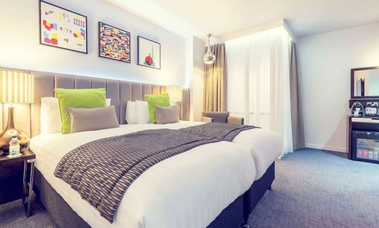 Bright and spacious day use twin room with work desk, sofa, mini bar and coffee maker at Mercure Hotel London Paddington.