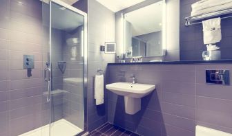 Guest bathroom with shower at Mercure Hotel London Paddington.